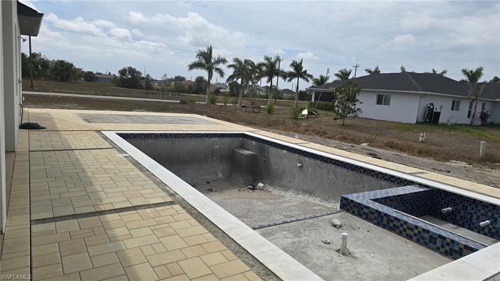 View of pool with an empty pool and patio surround