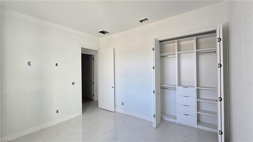 Unfurnished bedroom featuring baseboards and a closet