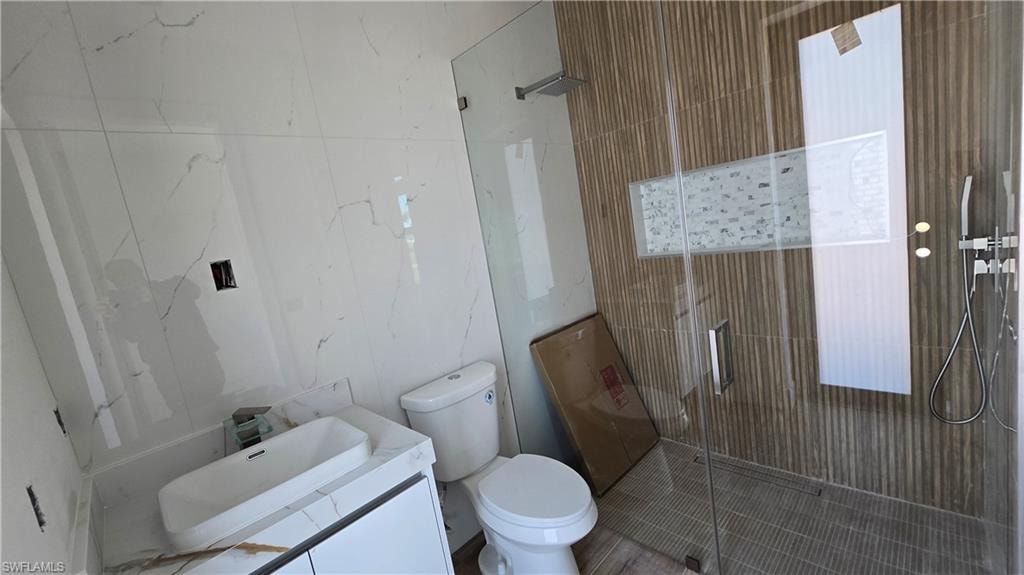 Full bathroom with a stall shower and vanity