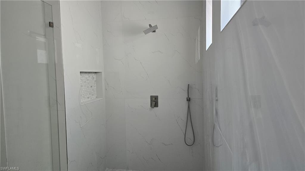 Bathroom view of a marble finish shower