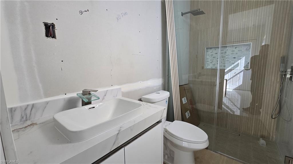 Full bath with vanity and a stall shower