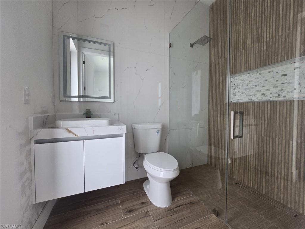 Full bath with vanity and a shower stall