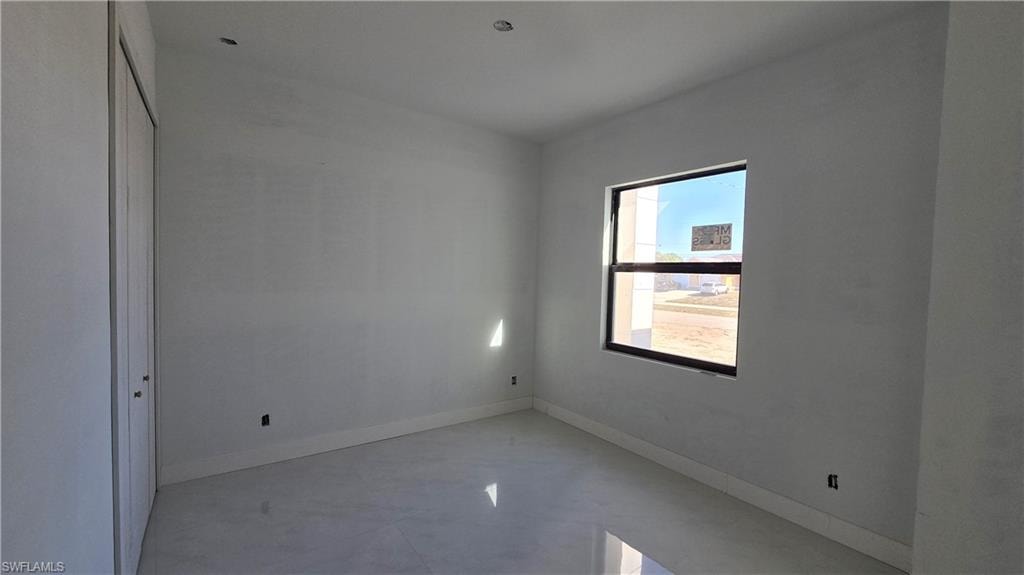 Unfurnished bedroom with a closet and baseboards