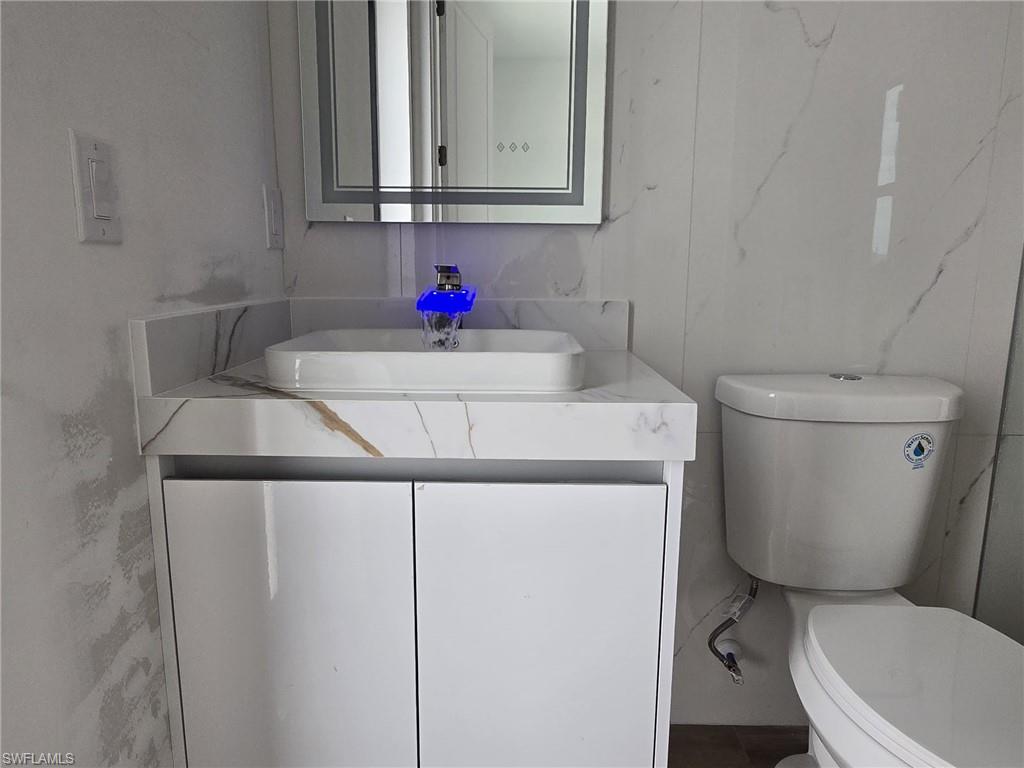 Bathroom featuring vanity and toilet