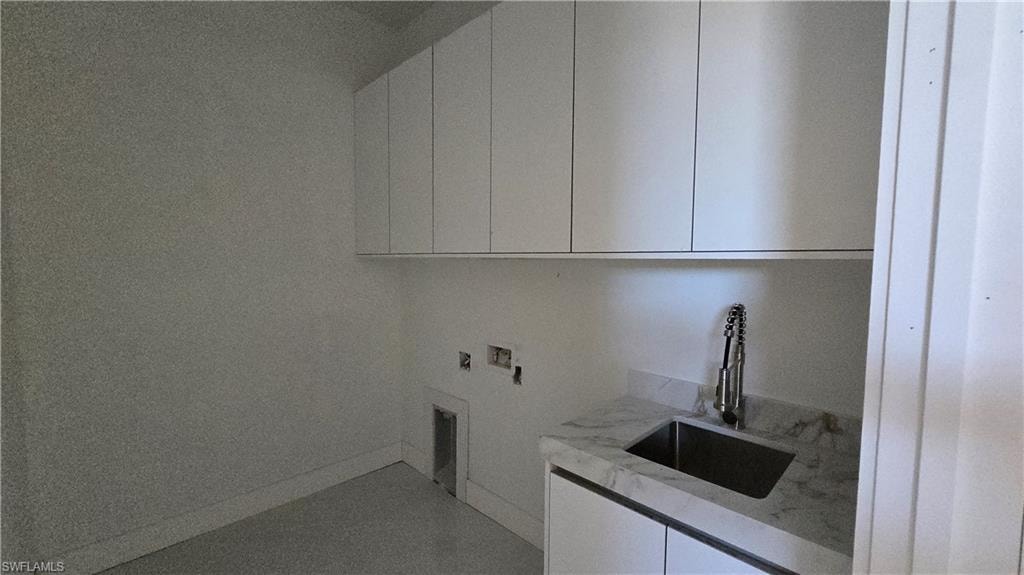 Laundry room with cabinet space and hookup for a washing machine