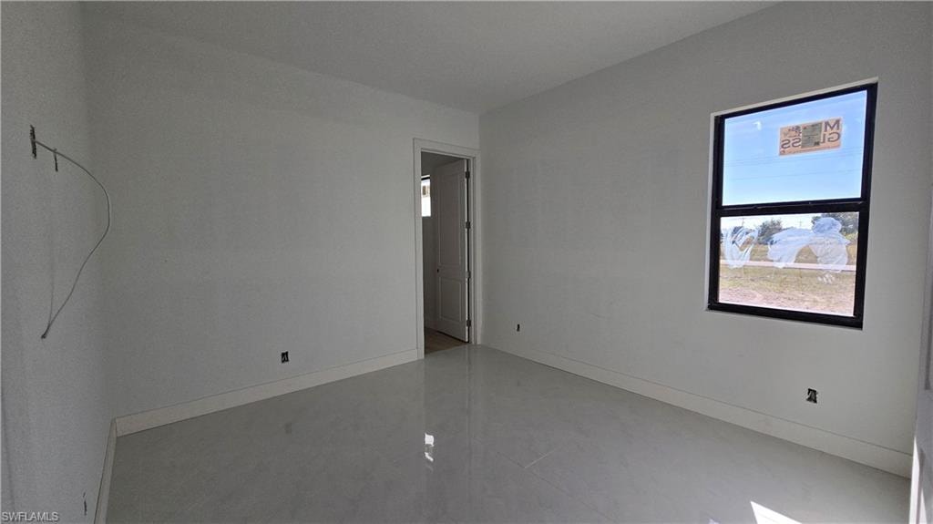 Empty room featuring baseboards