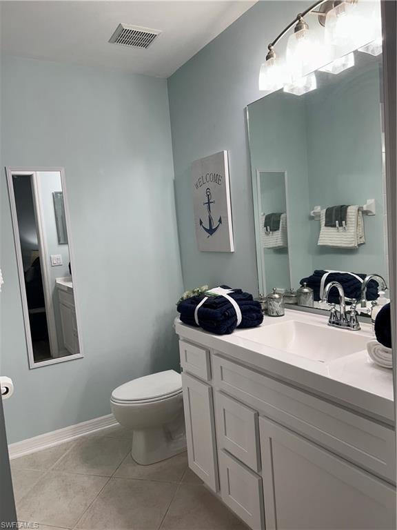 Bathroom vanity with white shaker-style cabinetry and a single integrated sink