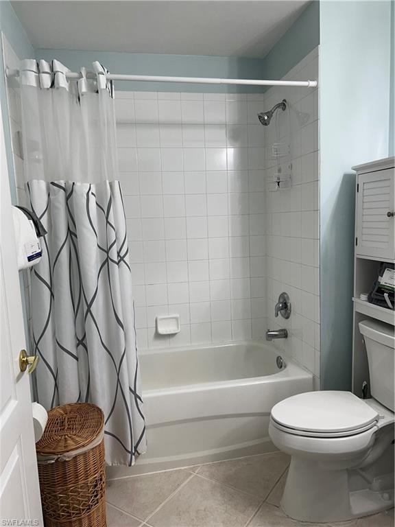 Bathroom featuring a white tub and shower combination with subway tile surround, chrome fixtures, and a white toilet
