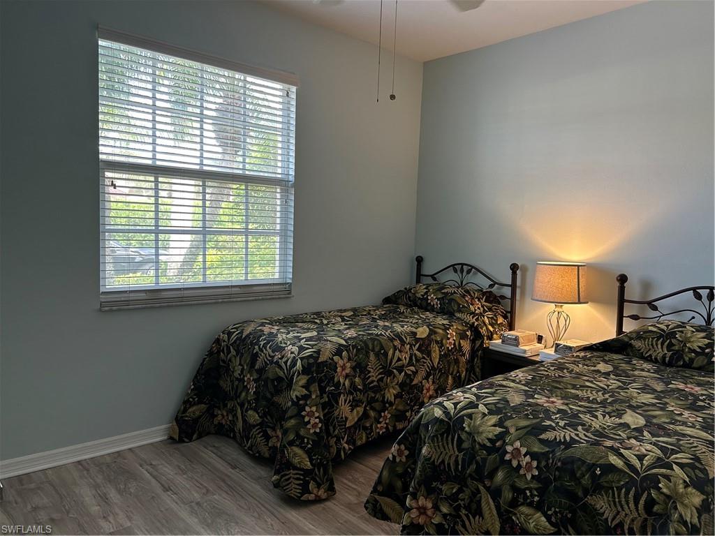 Room with wood-finish flooring and light blue walls