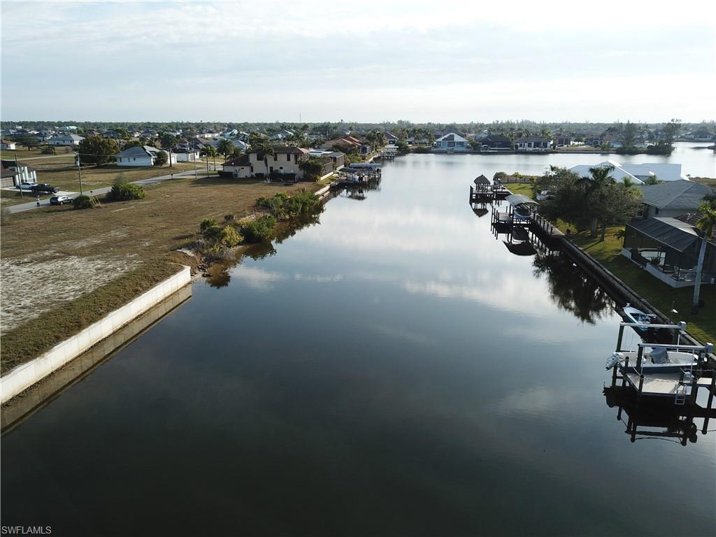 Water view featuring a boat dock and nearby suburban area