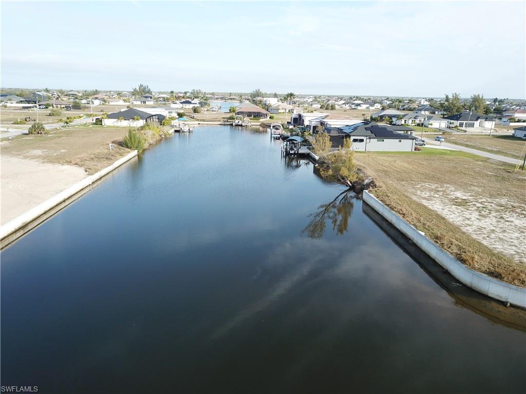 Aerial view of residential area featuring a large body of water