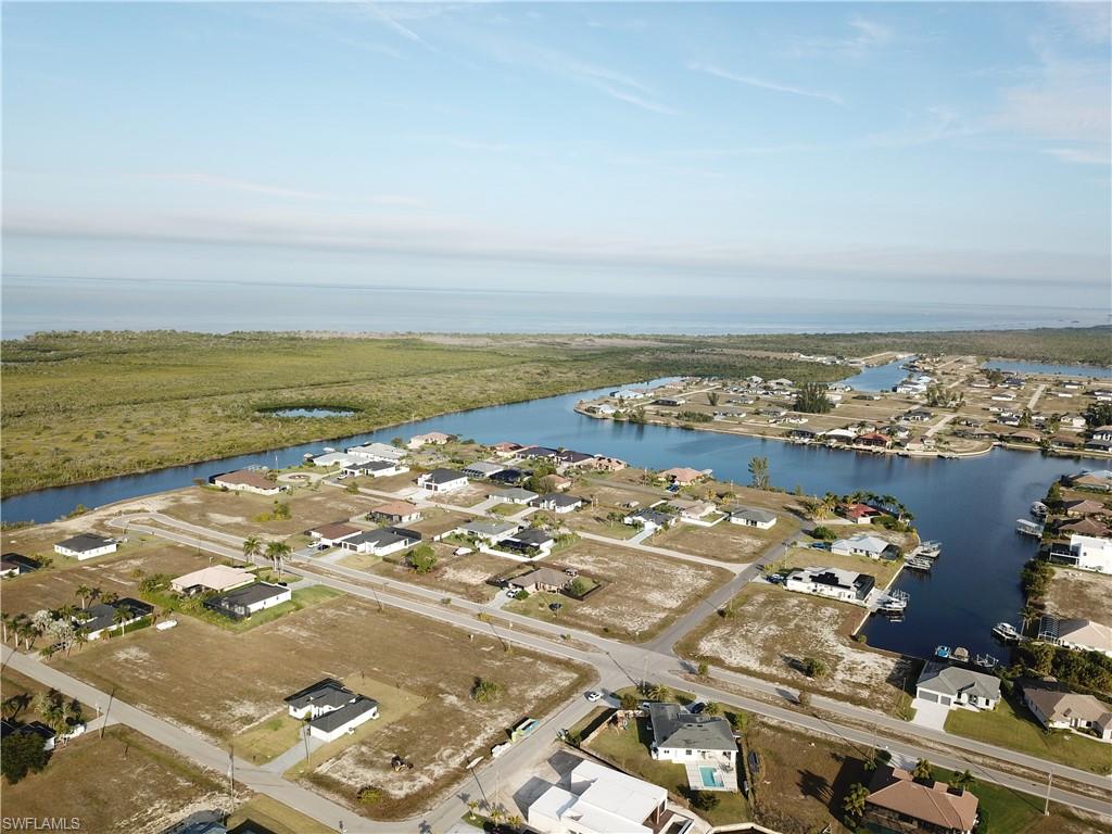 Aerial view of property's location featuring nearby suburban area and a nearby body of water