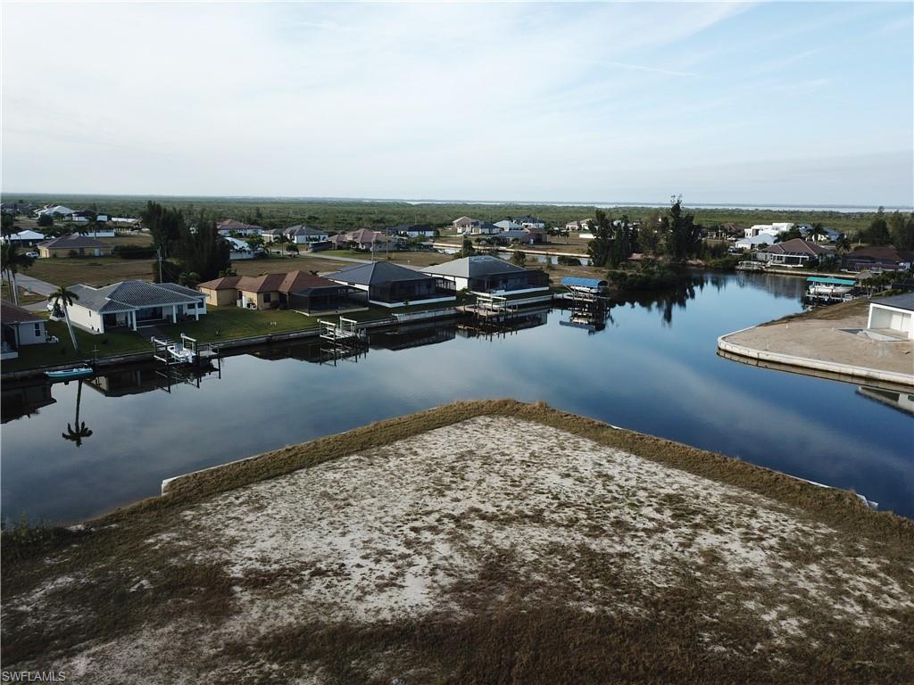 Aerial perspective of suburban area featuring a nearby body of water