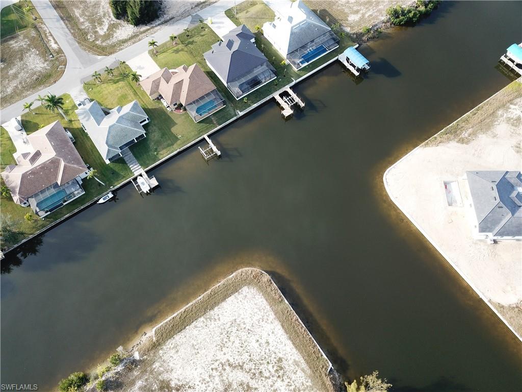 Aerial view of residential area featuring a nearby body of water