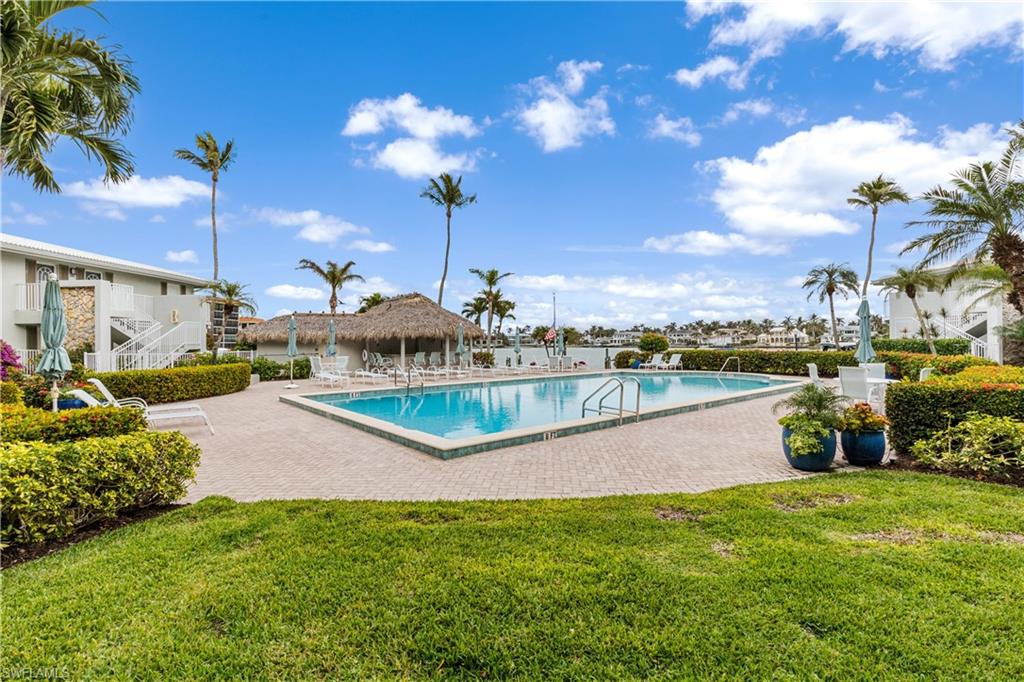 Community pool located on the bayside.  Cabana and docks in background near the bay.