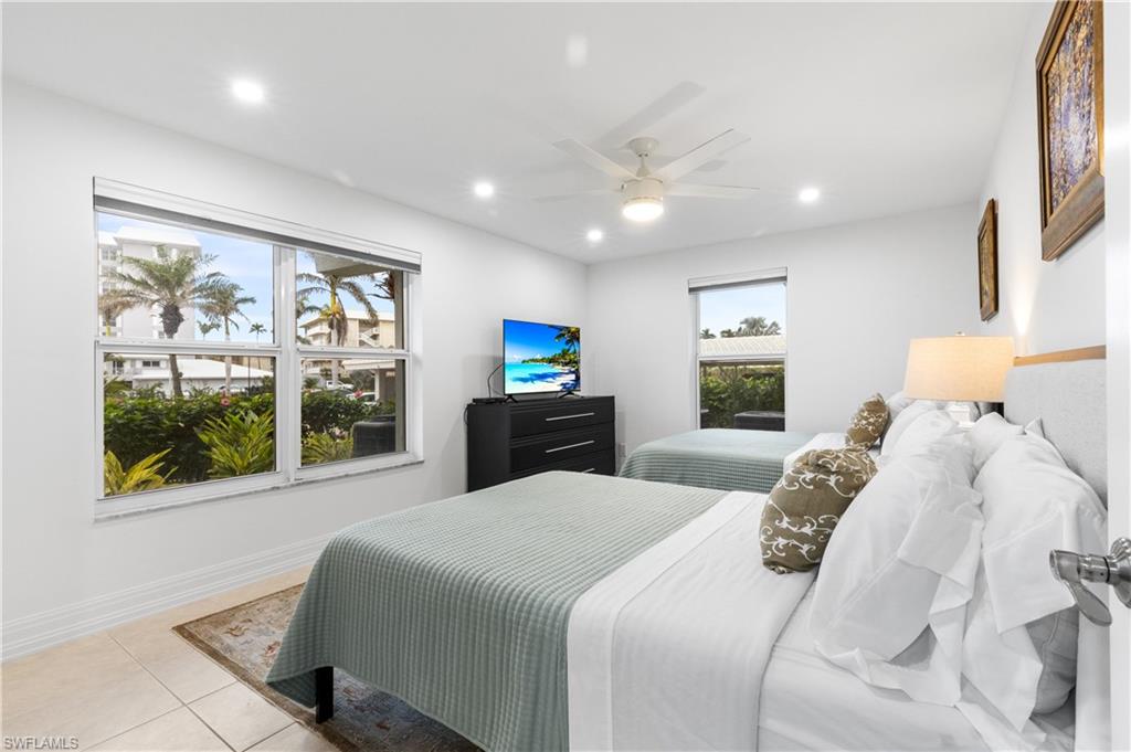 Spacious bedrrom shows 2 double beds with night stand between.  Bedroom has walk-in closet.