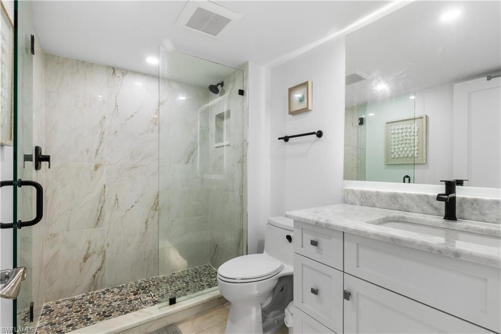 Totally updated bathroom with over-sized shower and accent lighting.  Marble counertops.