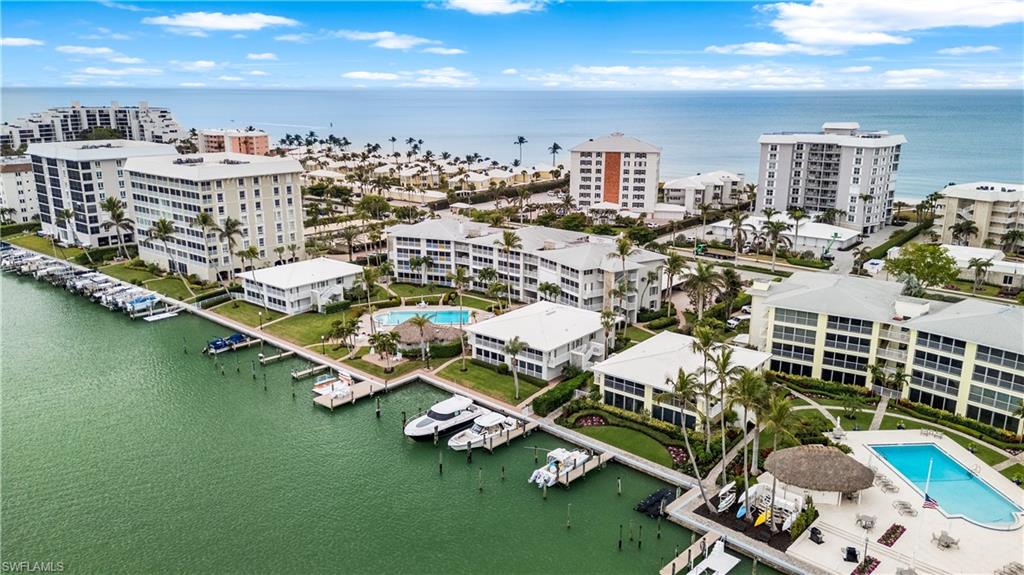 View from bay showing community pool, docks. Quick Gulf access through Doctor's Pass by Admiralty Point Condos, top left of photo.