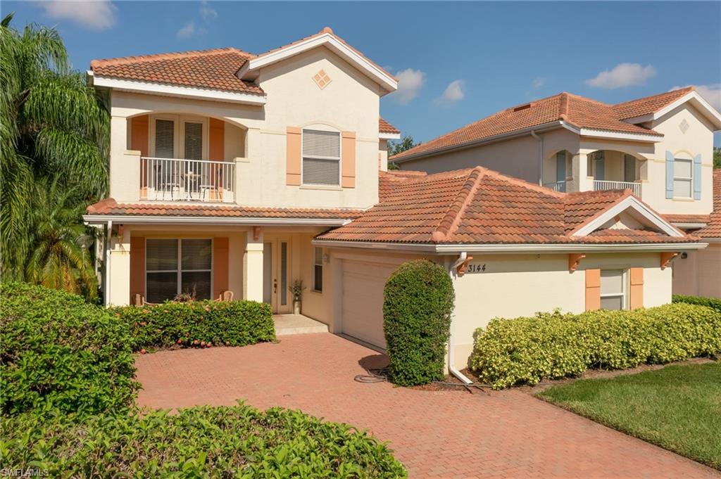 Mediterranean / spanish-style home with stucco siding, a balcony, and a tiled roof