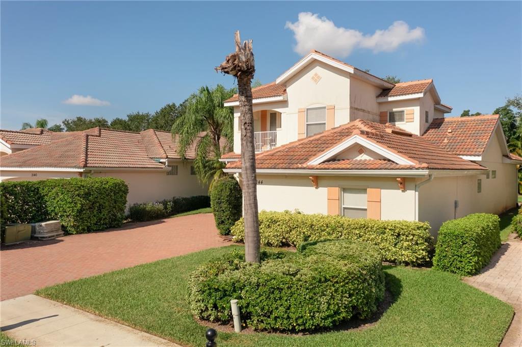 Mediterranean / spanish-style home featuring a tile roof, stucco siding, and a front yard