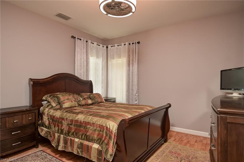 Bedroom with light wood-style floors and baseboards