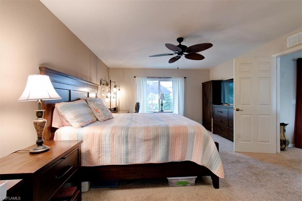 Bedroom with light carpet and ceiling fan