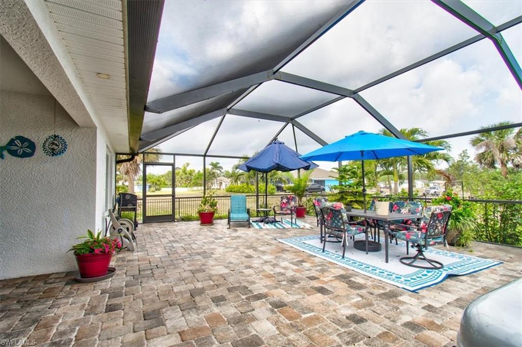 View of patio featuring a sunroom, a lanai, and outdoor dining area