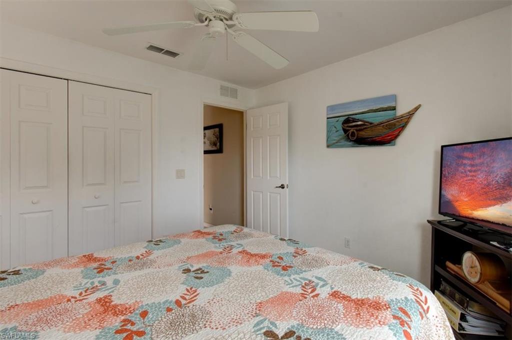 Bedroom featuring ceiling fan and a closet