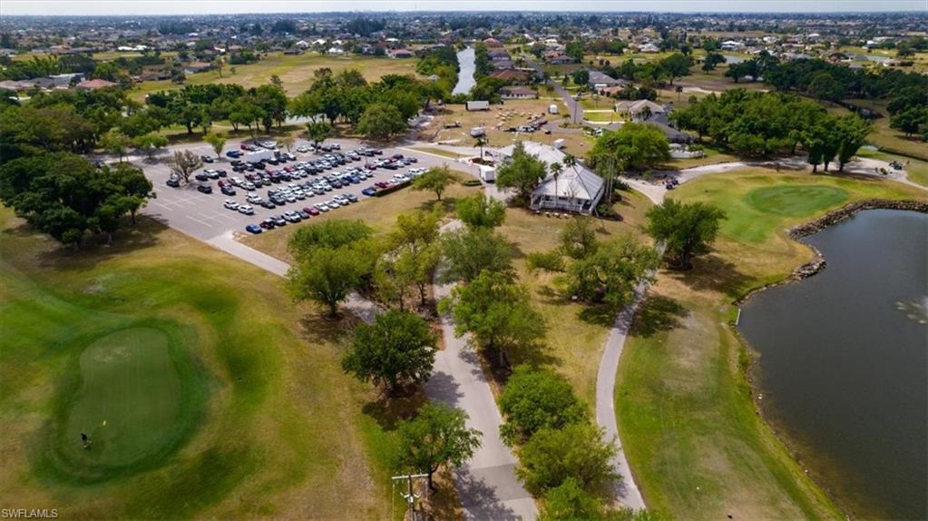 Aerial view of property and surrounding area featuring a golf course