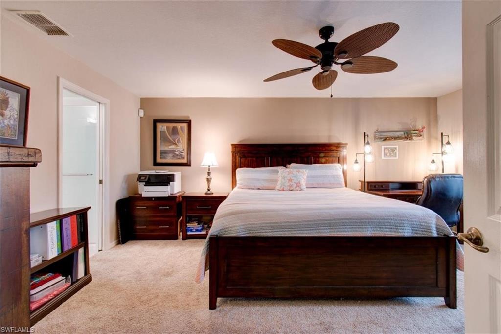 Bedroom with light colored carpet and ceiling fan