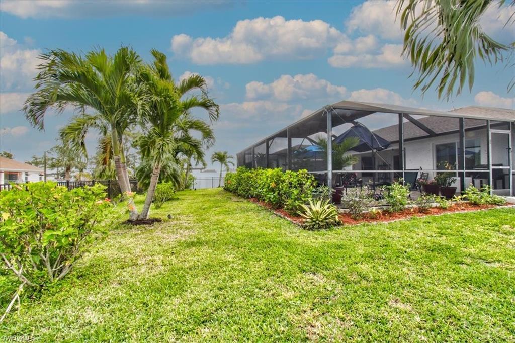 View of yard featuring glass enclosure and a sunroom