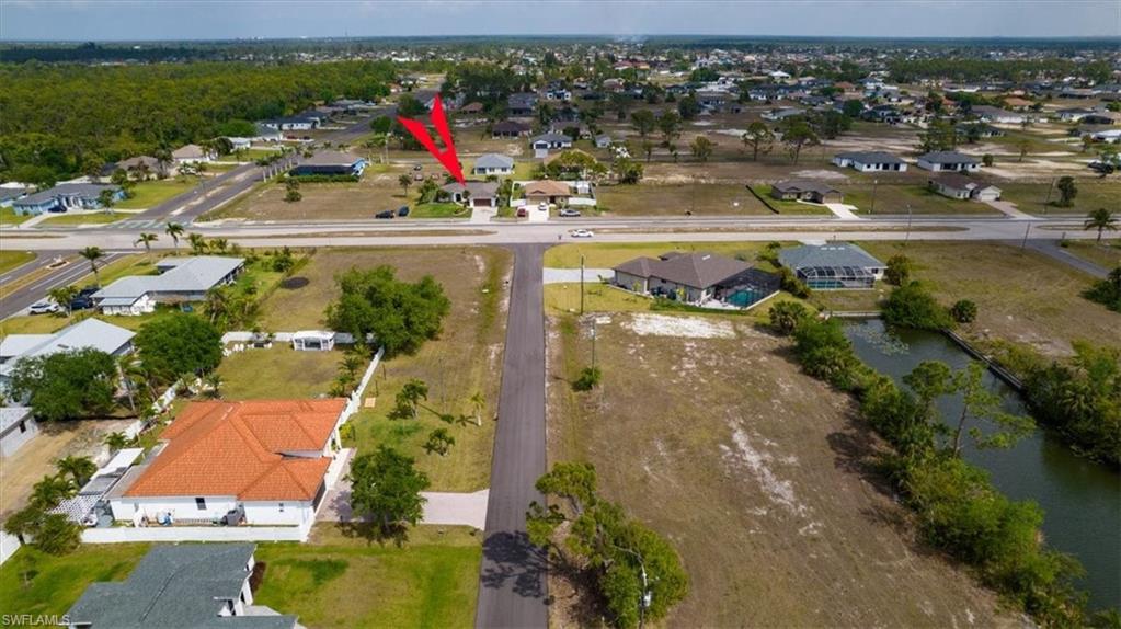 Aerial view of property's location featuring nearby suburban area