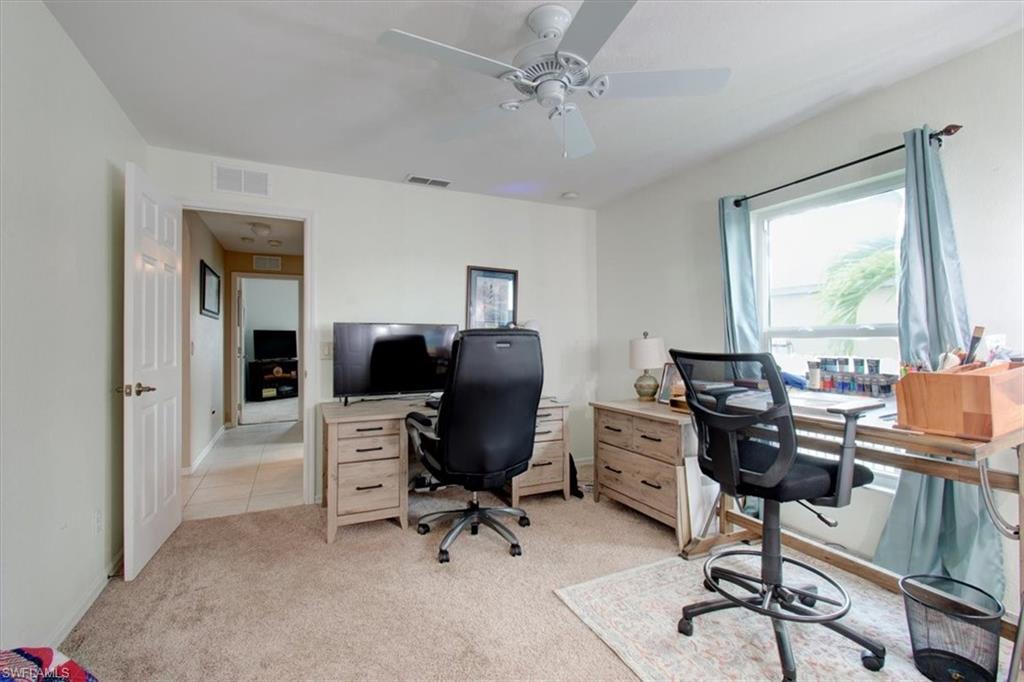Office featuring light colored carpet and a ceiling fan