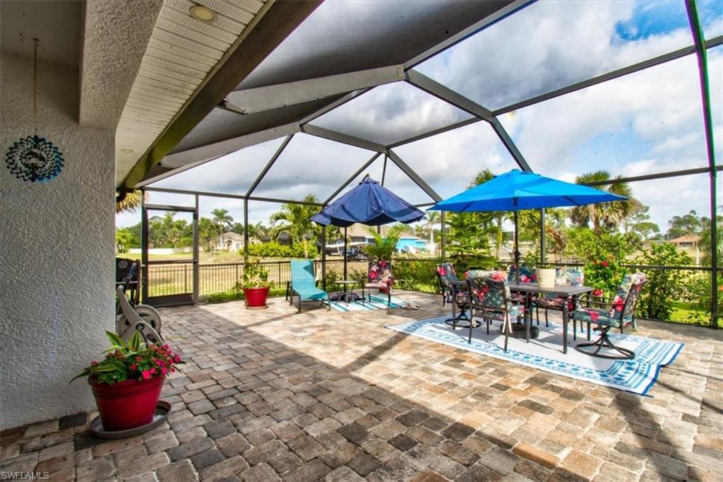 View of patio / terrace with glass enclosure, a sunroom, and outdoor dining space