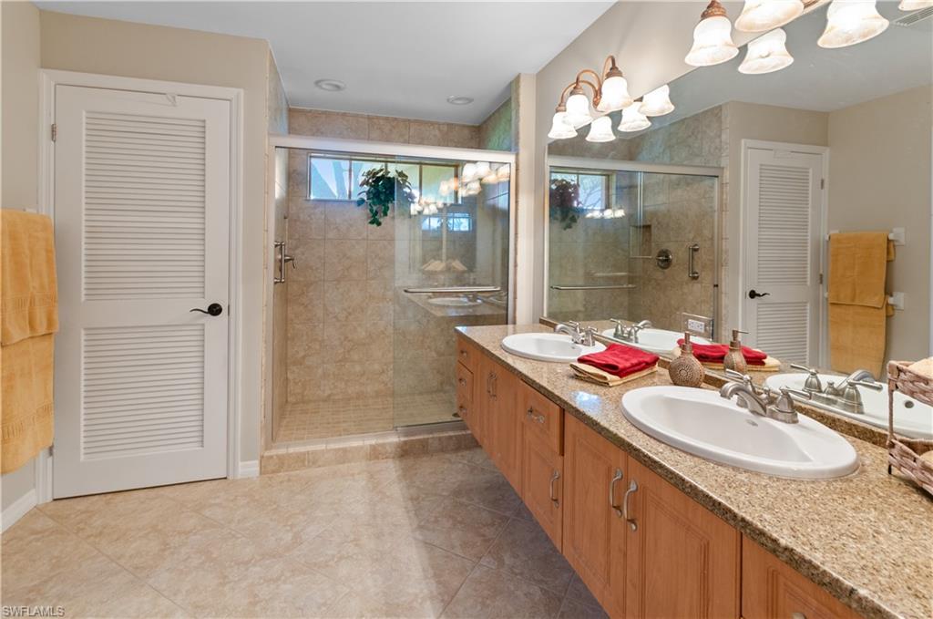 Large primary bathroom  with large closet, walk in shower and double sinks
