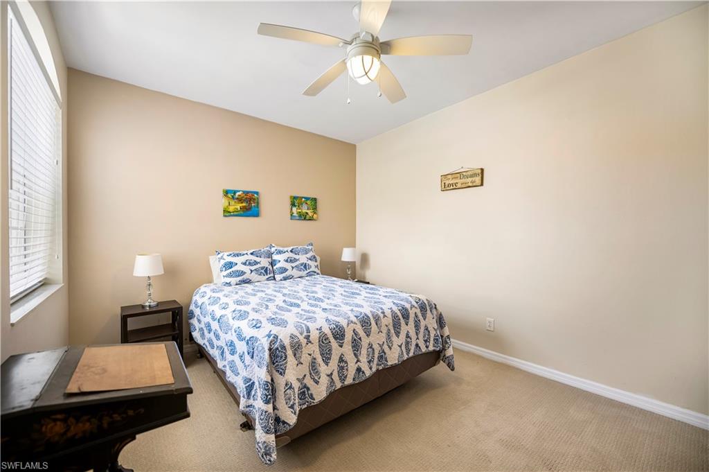 Nicely sized 2nd bedroom offers a queen bed and carpet.