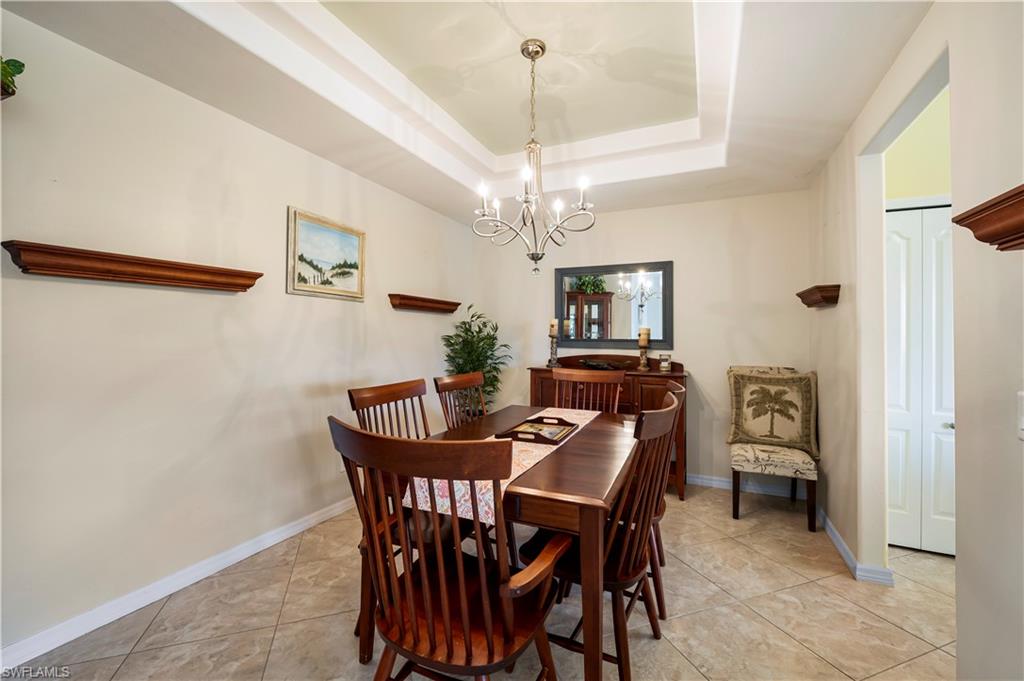 Formal dining room with double tray ceilings.