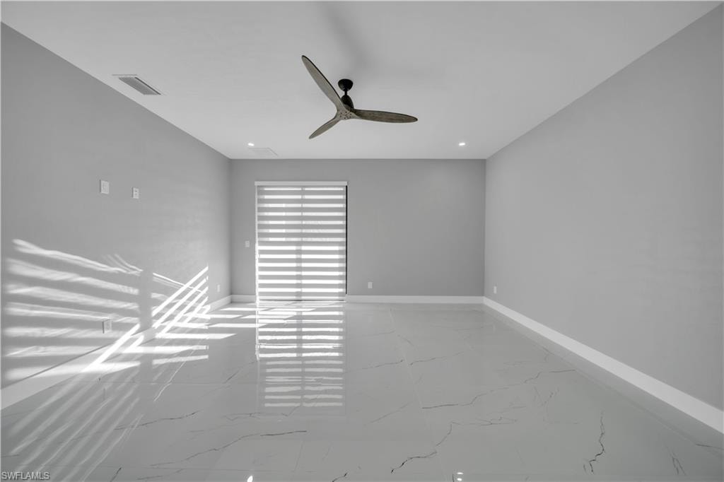 Spare room with light marble finish flooring, recessed lighting, and ceiling fan
