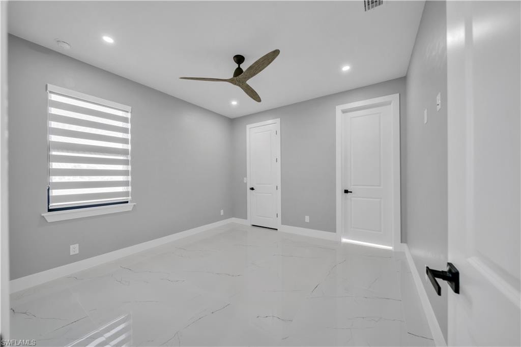 Unfurnished bedroom with recessed lighting, light marble finish flooring, and ceiling fan