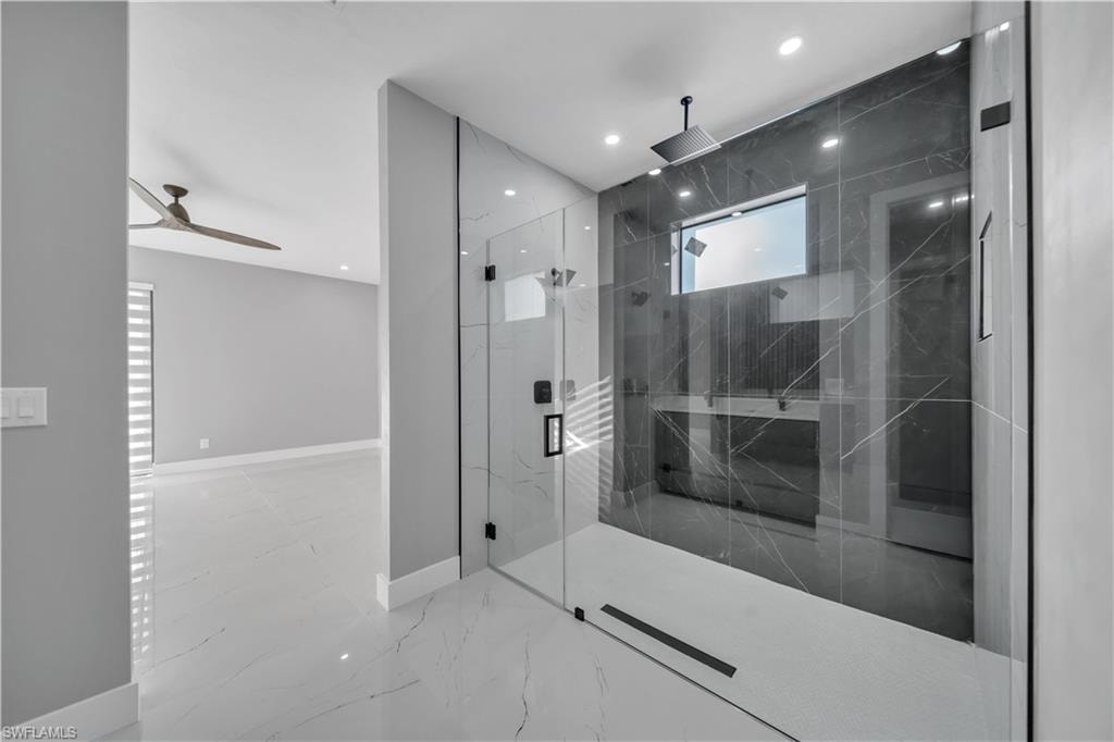 Full bath featuring a marble finish shower, light marble finish floors, a ceiling fan, and recessed lighting