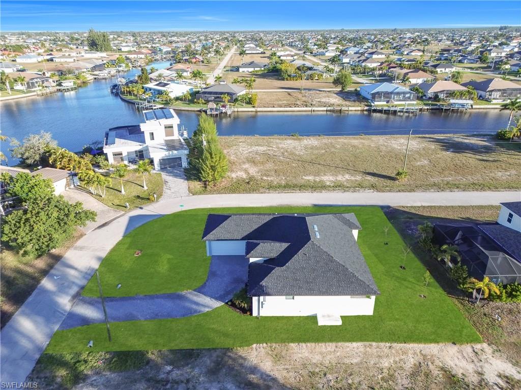 Aerial perspective of suburban area with a nearby body of water