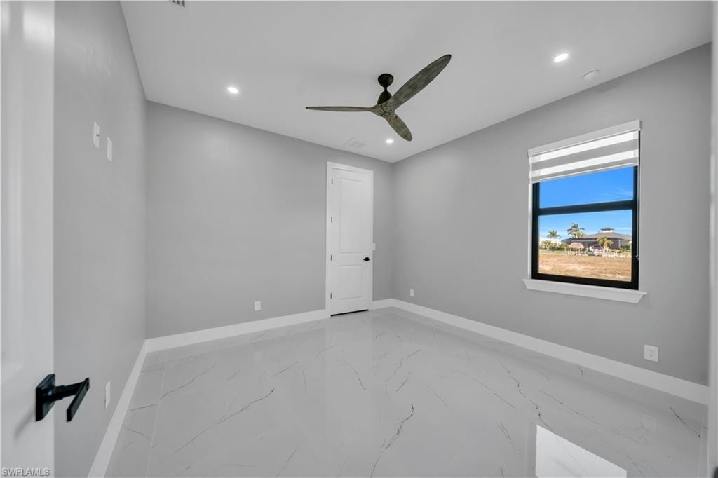 Spare room with light marble finish flooring, recessed lighting, and a ceiling fan