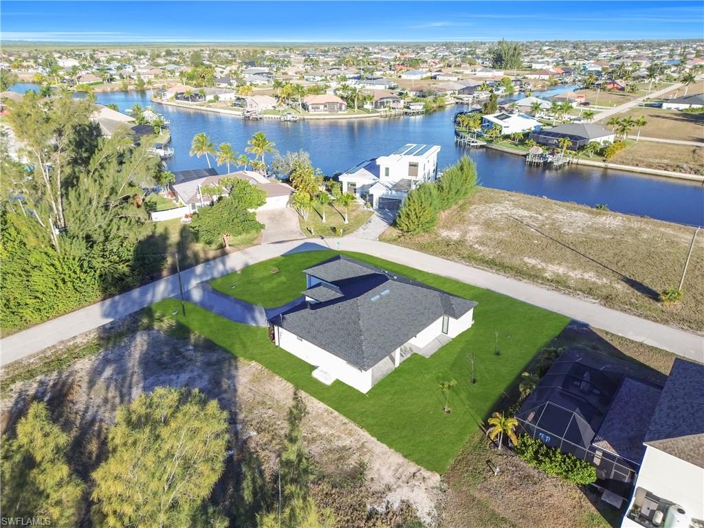 Aerial view of residential area featuring a nearby body of water