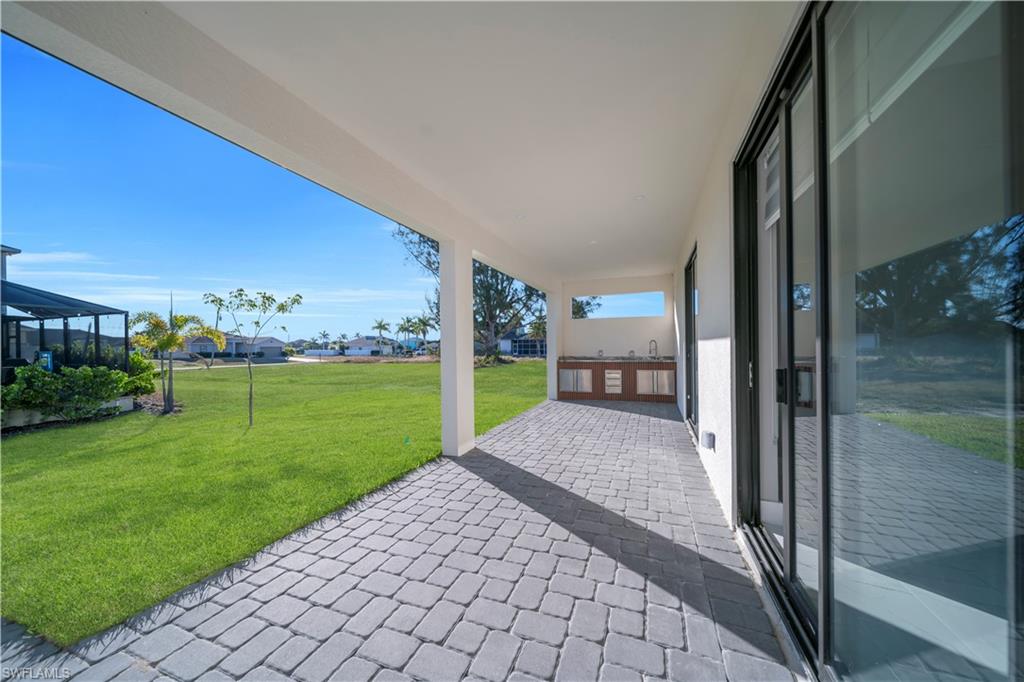 View of patio with a residential view and glass enclosure