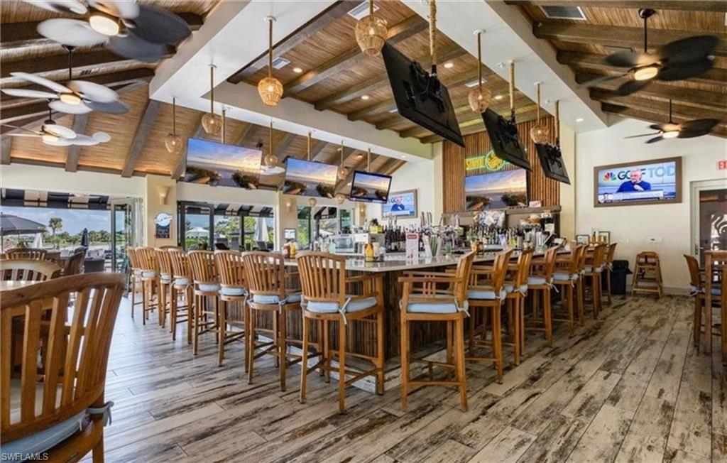 Bar featuring a ceiling fan, wooden ceiling, and decorative light fixtures