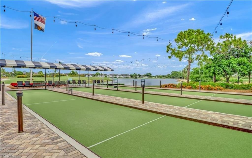 Surrounding community with a bocce ball area, a pergola, a water view, and a patio area