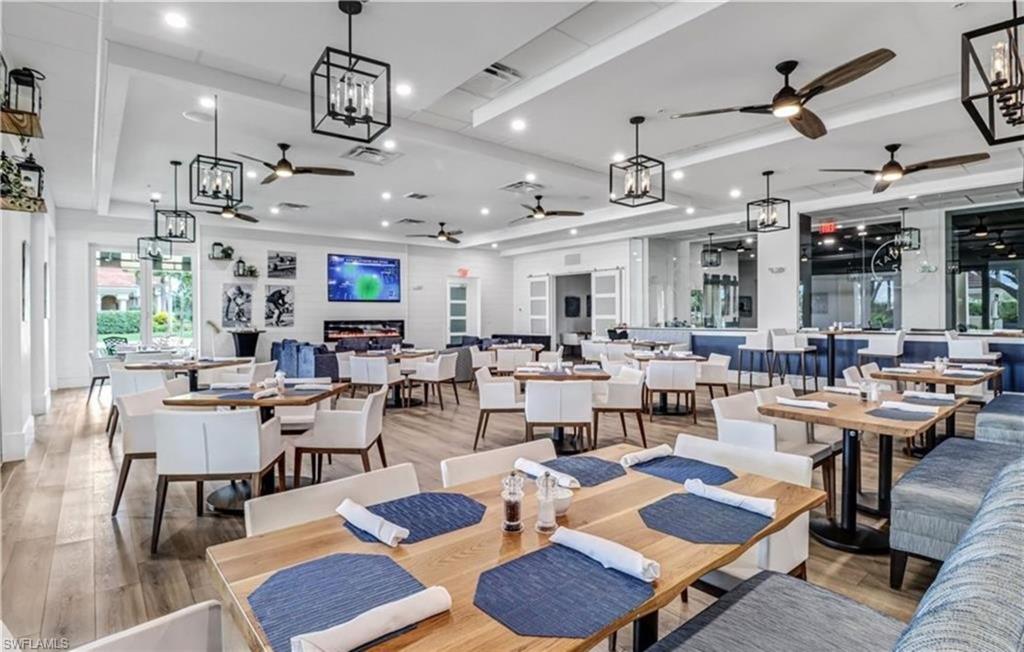 Dining room featuring healthy amount of natural light, recessed lighting, a chandelier, and a tray ceiling