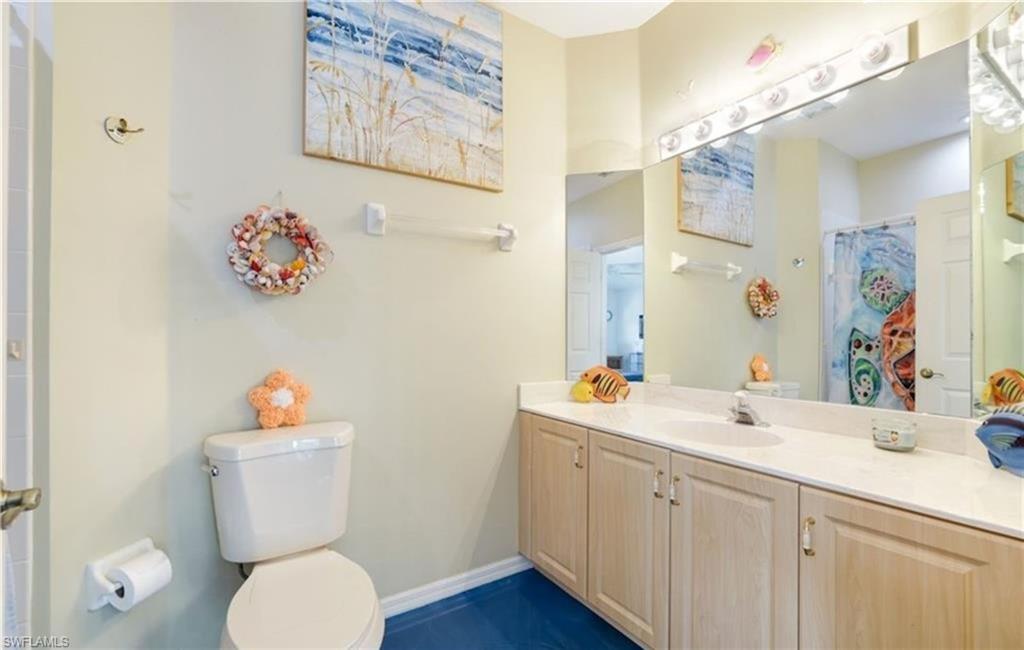 Full bath with a shower with curtain and vanity