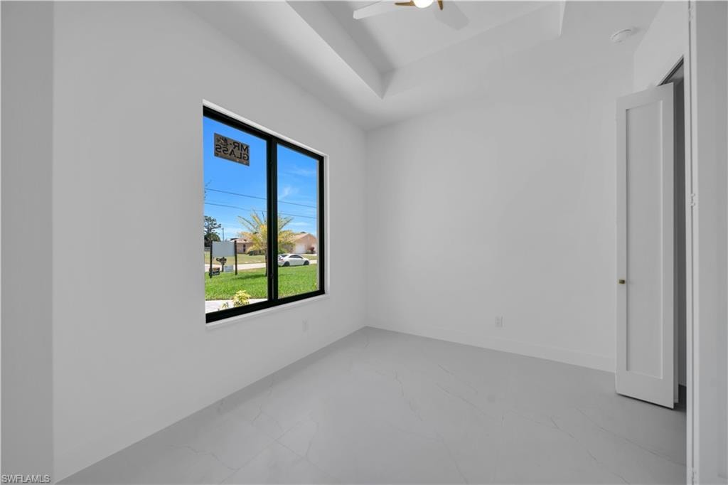Tray ceiling featuring a contemporary ceiling fan
