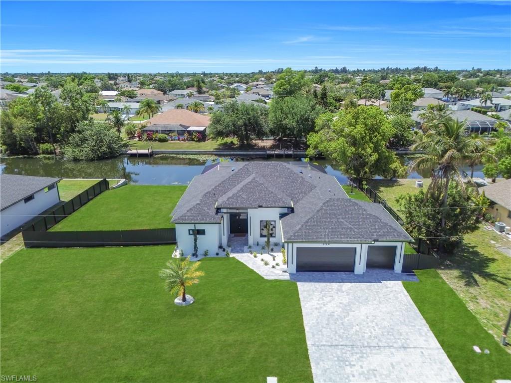Modern single-story residence featuring a dark shingle roof and a two-car garage